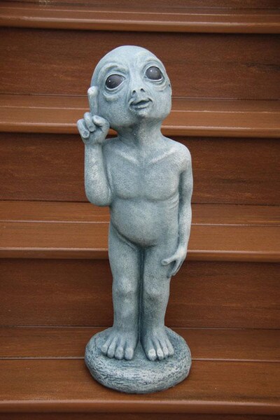 Heart Alien statue featuring an extraterrestrial point at the sky space man